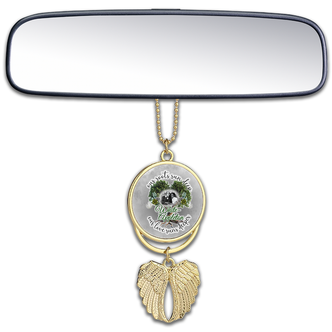 Gold car mirror pendant with wings and White-Appleton couple photo centerpiece.